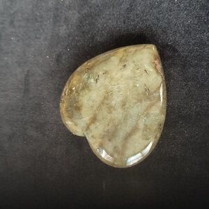 Polished dark-green heart-shaped meditation stone